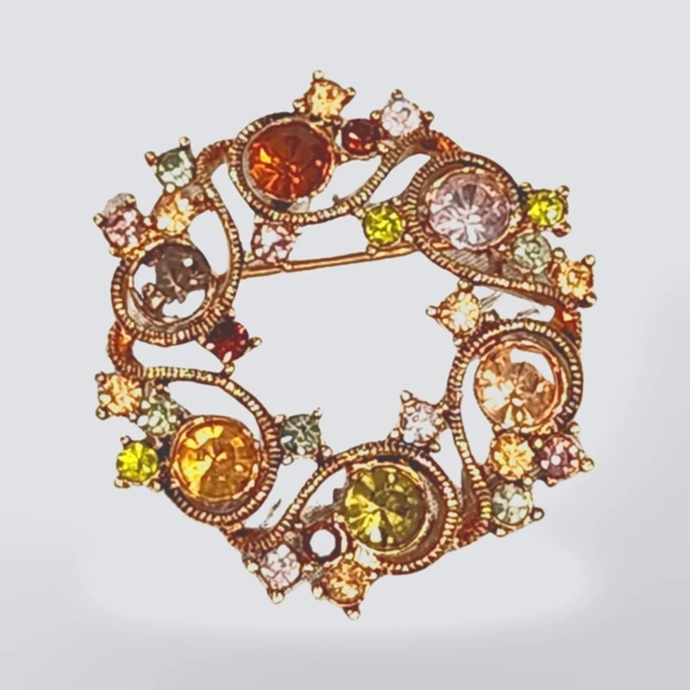 Lovely vintage Monet gold tone‎ multi colored rhinestone circle brooch